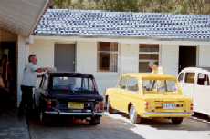 Two S.A. Hillman GTs (�Imps�) getting a wash and polish for the weekend